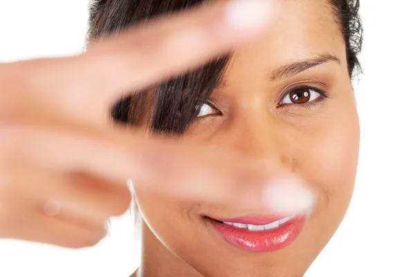 Portrait of a woman showing victory sign — Stock Photo, Image