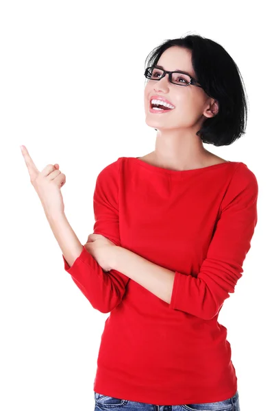 Portrait of young woman pointing up — Stock Photo, Image
