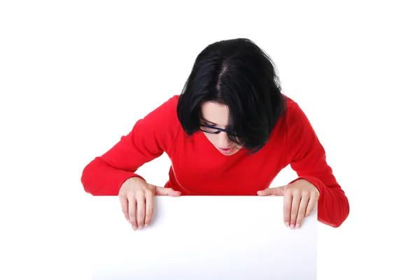 Surprised woman with white empty banner — Stock Photo, Image