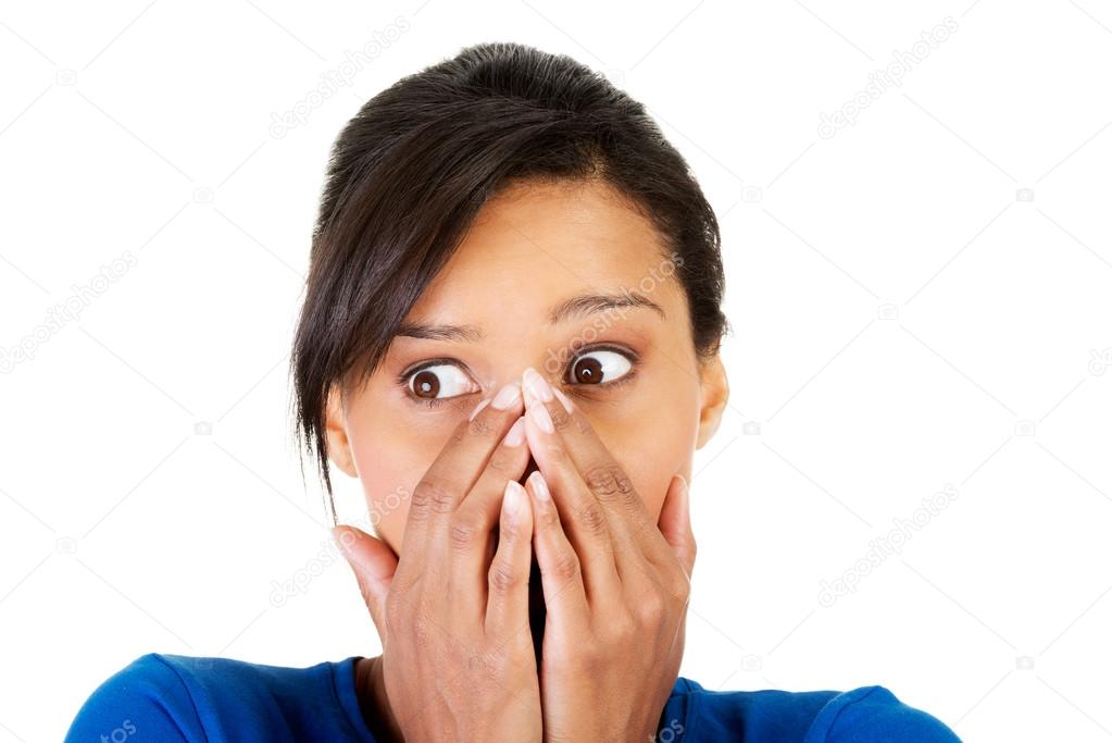Surprised woman covering with hands her mouth