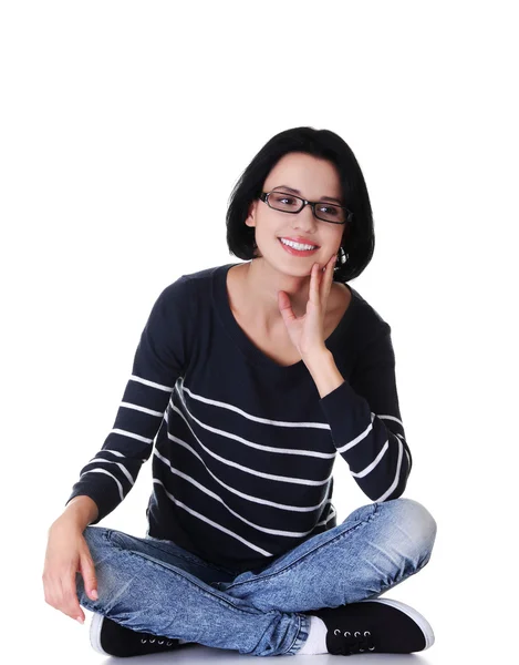 Happy student sitting cross-legged on the floor — Stock Photo, Image