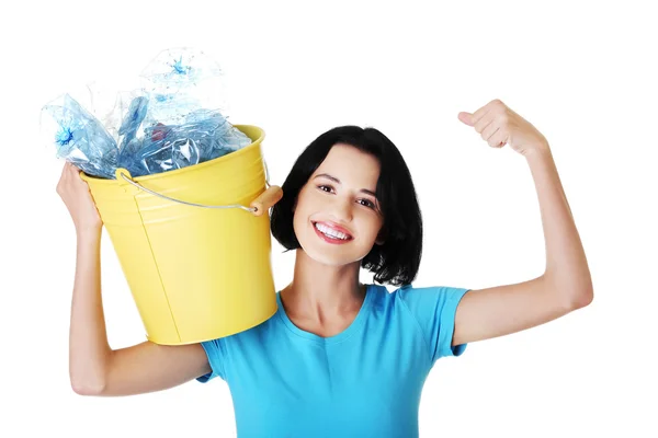Happy woman holding bucket of plastic rubbish — Stock Photo, Image