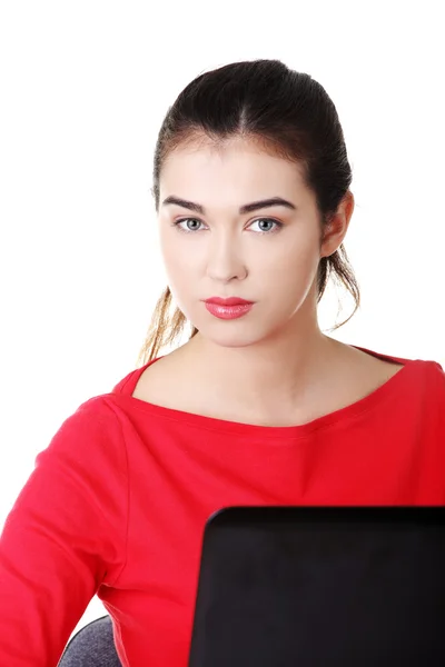 Vista frontale donna seduta alla scrivania con computer portatile — Foto Stock