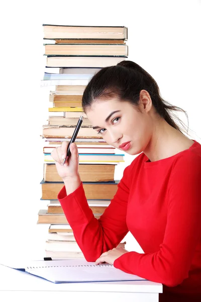 Side view woman sitting with stack of books — Stock Photo, Image
