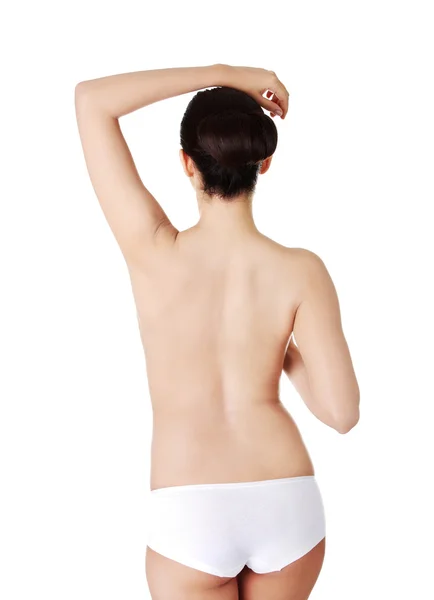Vista posterior delgada mujer en topless en ropa interior —  Fotos de Stock