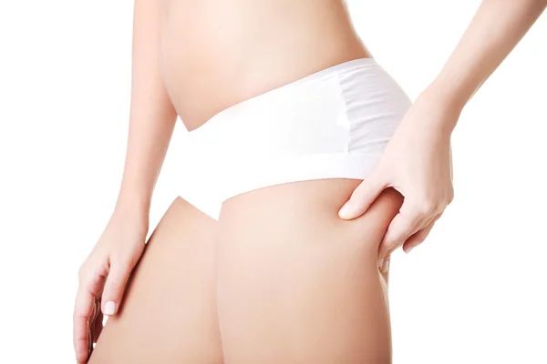 Side view of slim woman checking fat on buttocks — Stock Photo, Image