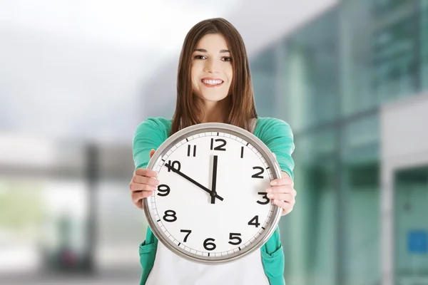 Happy woman holding office clock — Stock Photo, Image