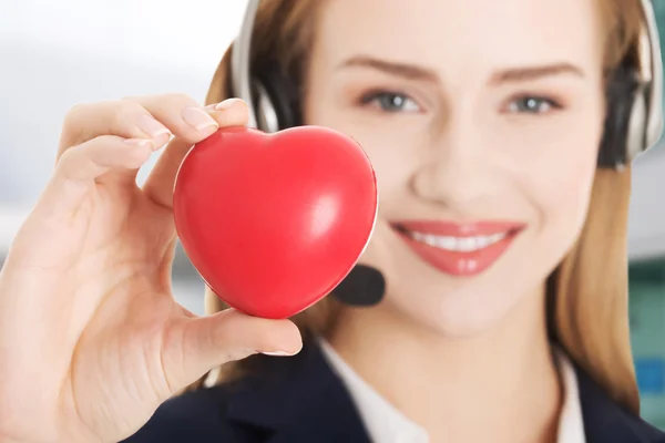 Young call center woman holding heart. — Stock Photo, Image