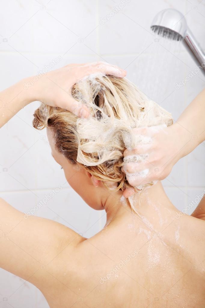 Woman taking shower washing her hair