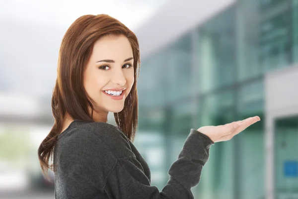 Woman showing something on copyspase — Stock Photo, Image