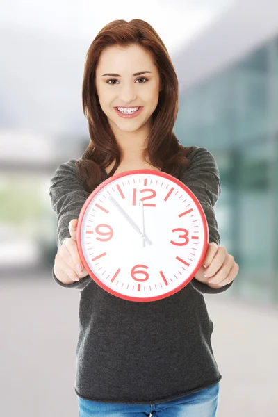 Happy woman holding office clock — Stock Photo, Image