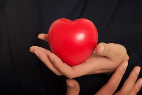 Coeur rouge dans les mains de la femme — Photo