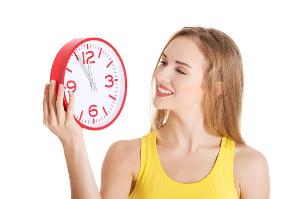 Atractiva joven mujer sosteniendo un reloj . —  Fotos de Stock