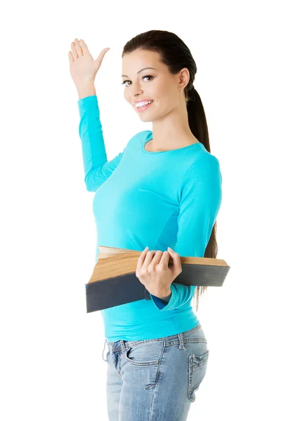 Woman holding open book and showing copyspace — Stock Photo, Image