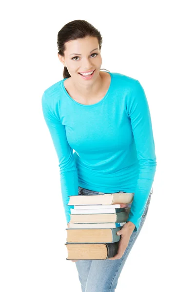 Estudante mulher segurando livros pesados — Fotografia de Stock