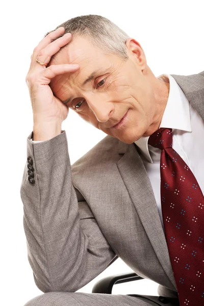 Stressed businessman sitting on armchair — Stock Photo, Image