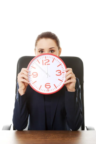 Businesswoman with big clock at the office Royalty Free Stock Photos