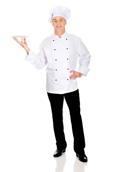 Szef kuchni gospodarstwa biały Porcelanowy talerz — Zdjęcie stockowe