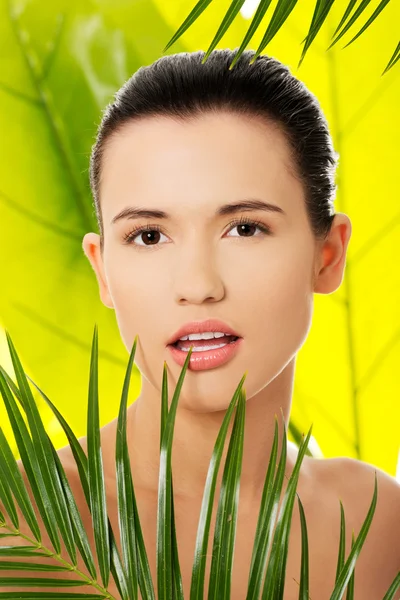 Woman with green leaves — Stock Photo, Image