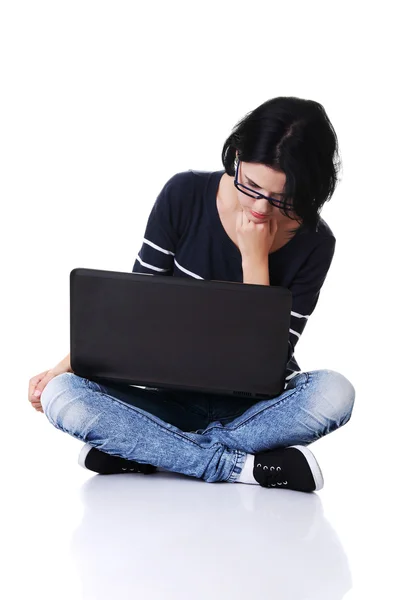 Pensive woman sitting with laptop — Stock Photo, Image