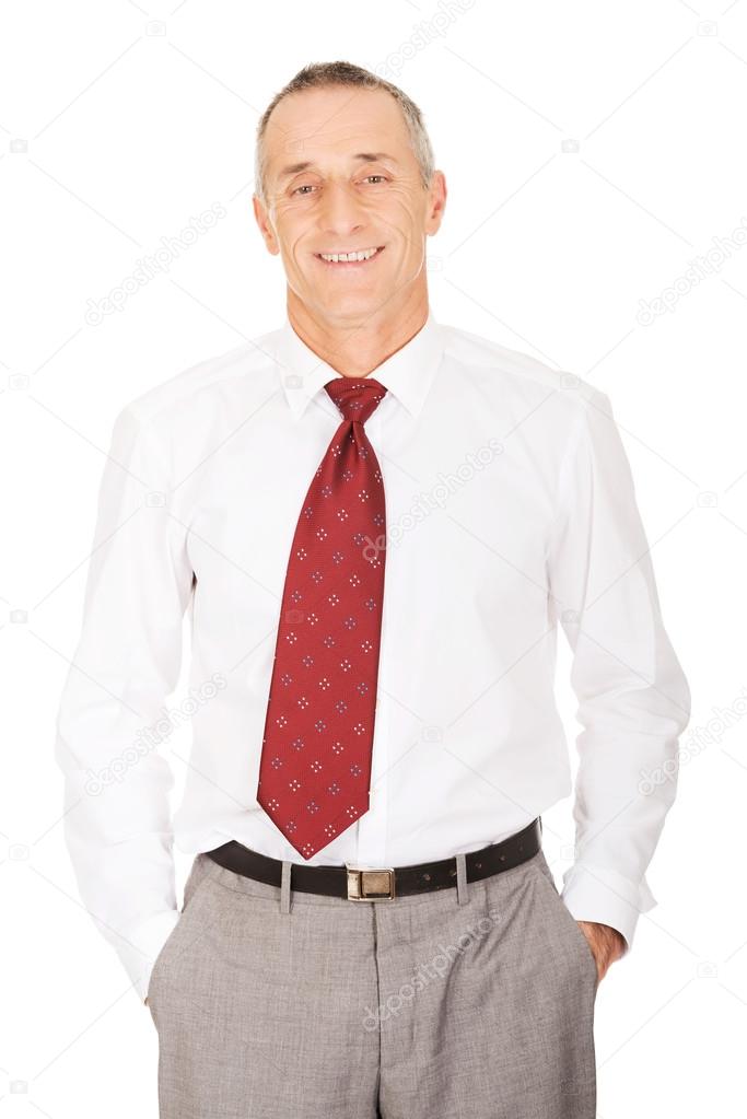 Smiling businessman with hands in pocket