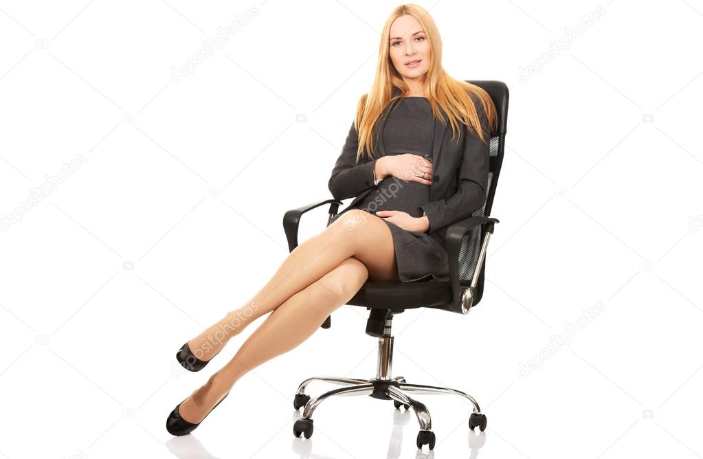 Pregnant woman sitting on armchair