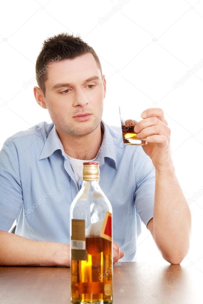 Yound man in depression, drinking alcohol