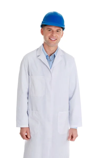 Man in a lab coat and helmet — Stock Photo, Image