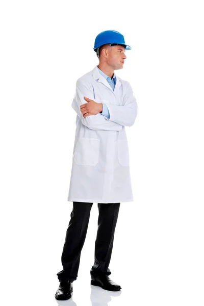 Man in a lab coat and helmet — Stock Photo, Image