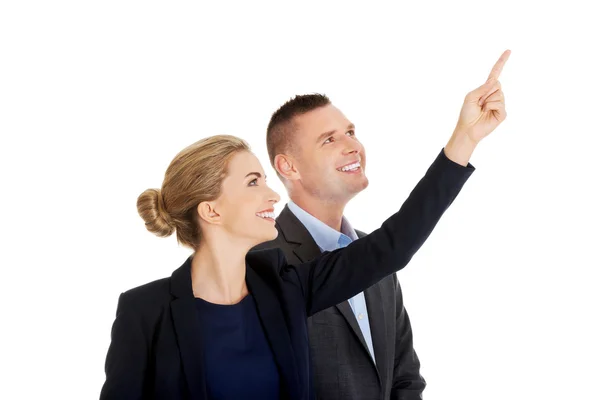 Successful business couple pointing away — Stock Photo, Image