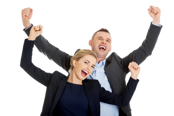 Victorious business couple with hands up — Stock Photo, Image