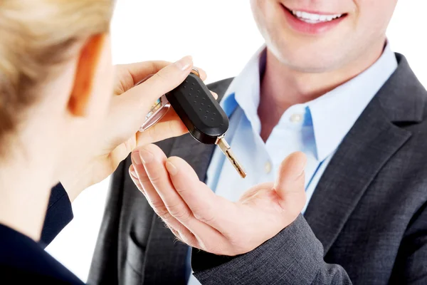 Car salesman handing over the keys — Stock Photo, Image