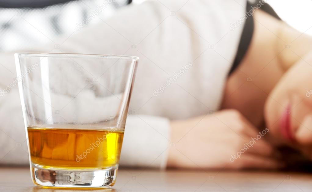 Yound woman in depression, drinking alcohol