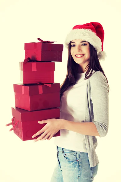Young santa woman holding stack of presents. — Stock Photo, Image