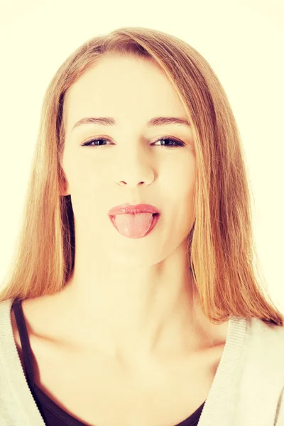 Beautiful blond woman showing her tongue. Stock Photo