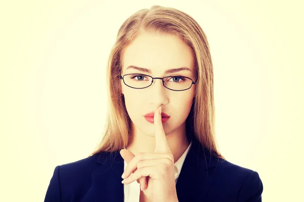 Business woman with finger on lips. — Stock Photo, Image