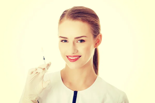 Beautiful young nurse or doctor with needle. — Stock Photo, Image