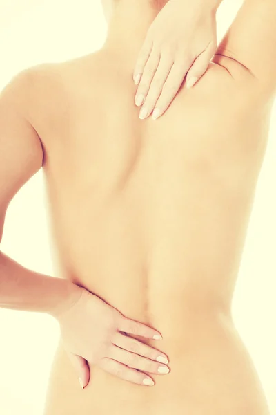 Donna nuda sta toccando la schiena . — Foto Stock