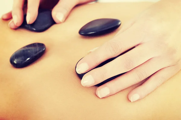 Females back having stone massage. — Stock Photo, Image