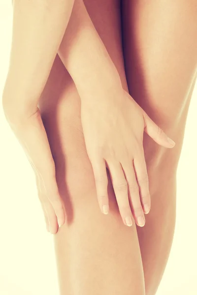 Beautiful smooth knees with hands. — Stock Photo, Image