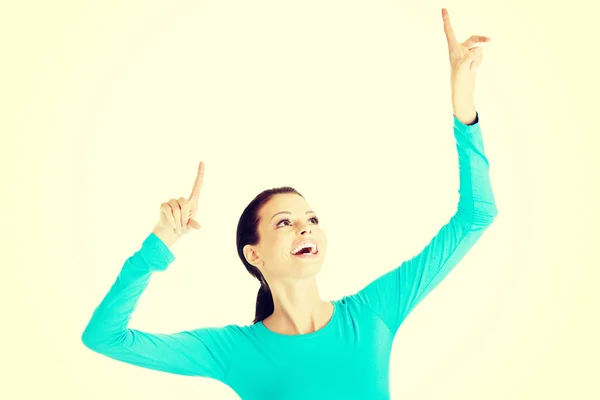 Young beautiful woman pointing up. — Stock Photo, Image