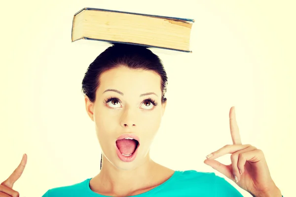 Beautiful woman with book on her head. — Stock Photo, Image