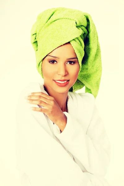 Attractive woman in bathrobe and turban on head — Stock Photo, Image