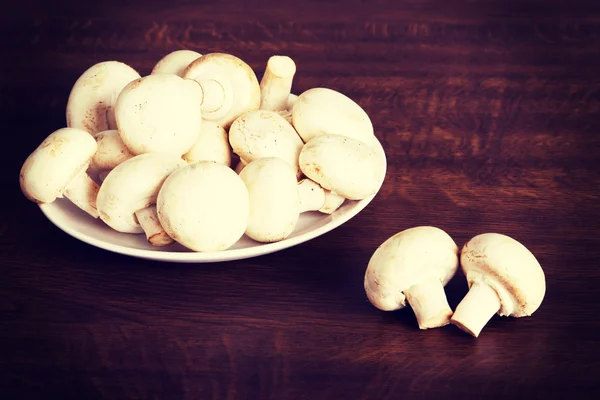 Fresh raw mashroom lying on a plate. — Stock Image Fresh raw mashroom lying on a plate. Stock Picture