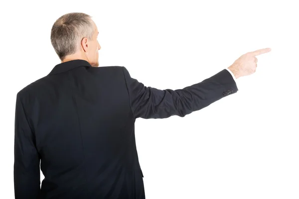 Businessman pointing to the right — Stock Photo, Image