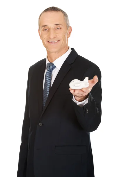 Businessman holding small airplane — Stock Photo, Image