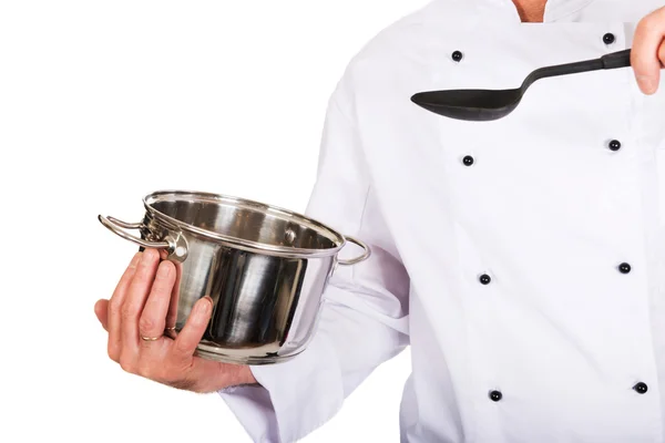 Kockens hand med stål pott och sked — Stockfoto