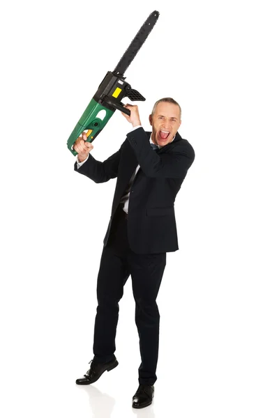 Angry businessman with chainsaw — Stock Photo, Image