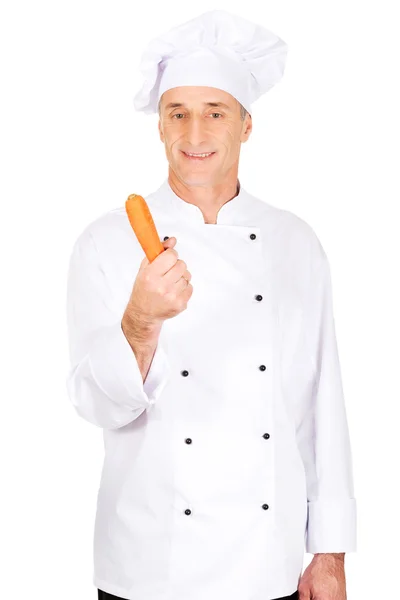 Male chef with a carrot — Stock Photo, Image