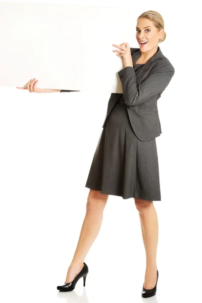 Businesswoman holding empty billboard — Stock Photo, Image